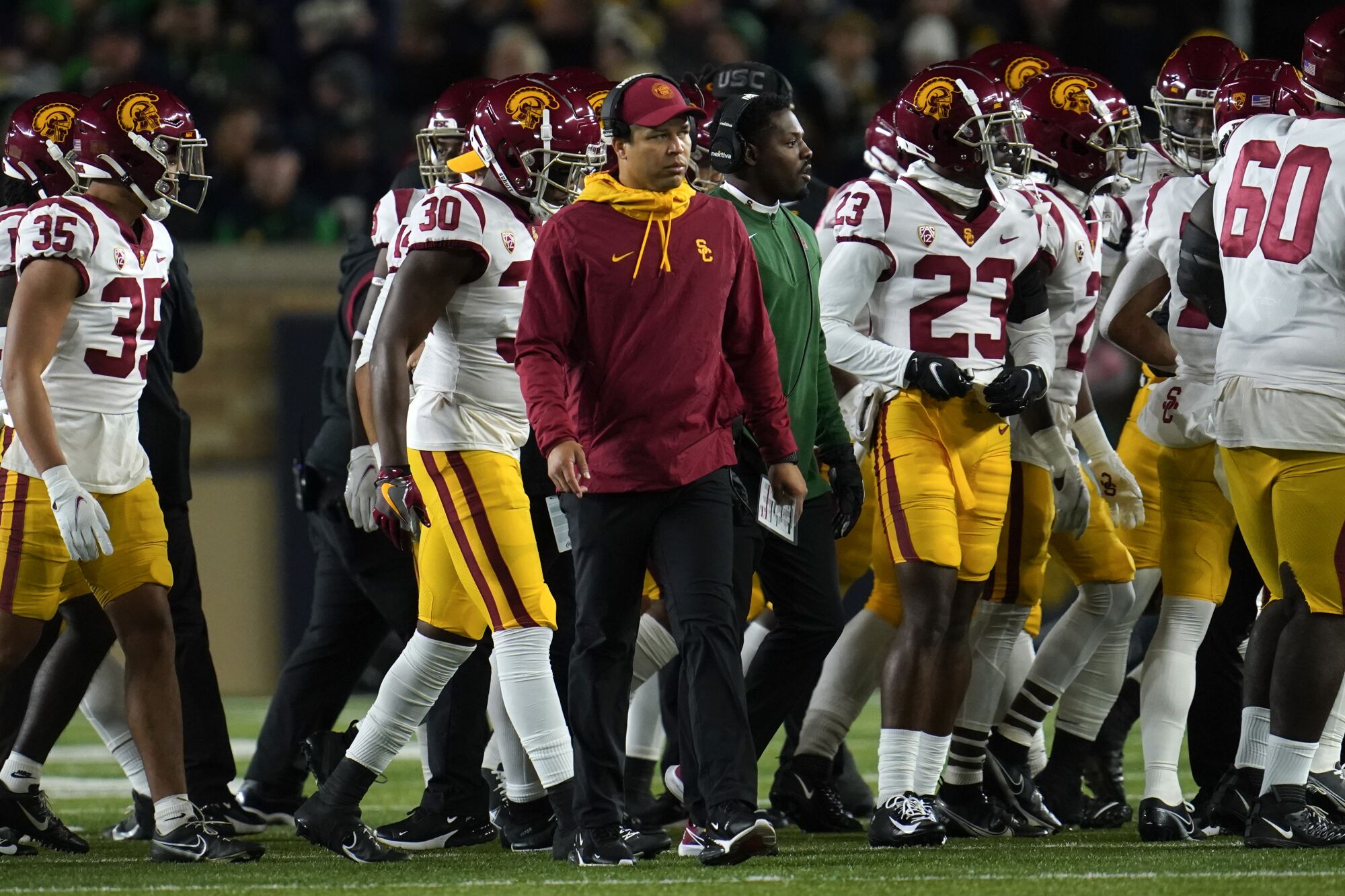 USC coach Donte Williams stands beside his players during the Trojans' loss to Notre Dame last week