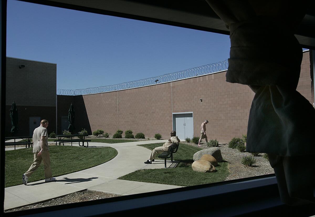 Patients in one of the numerous outdoor courtyards during a lunch break at Coalinga State Hospital.