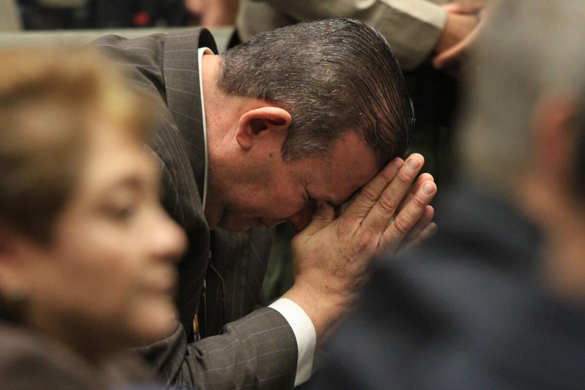 Former Bell Councilman Luis Artiga reacts after being acquitted on all charges. Teresa Jacobo is seen in foreground.