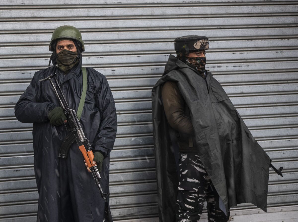 Indian paramilitary soldiers stand guard in Srinagar, Indian controlled Kashmir, Saturday, Jan. 8, 2022. The New York-based Committee to Protect Journalists asked Indian authorities to immediately release journalist Sajad Gul in disputed Kashmir, days after police arrested him for uploading a video clip of a protest against Indian rule. Indian soldiers picked up Gul from his home in northeastern Shahgund village on Wednesday night and later handed him over to the police, his family said. He had posted a video of family members and relatives protesting the killing of a rebel commander on Monday. (AP Photo/Mukhtar Khan)