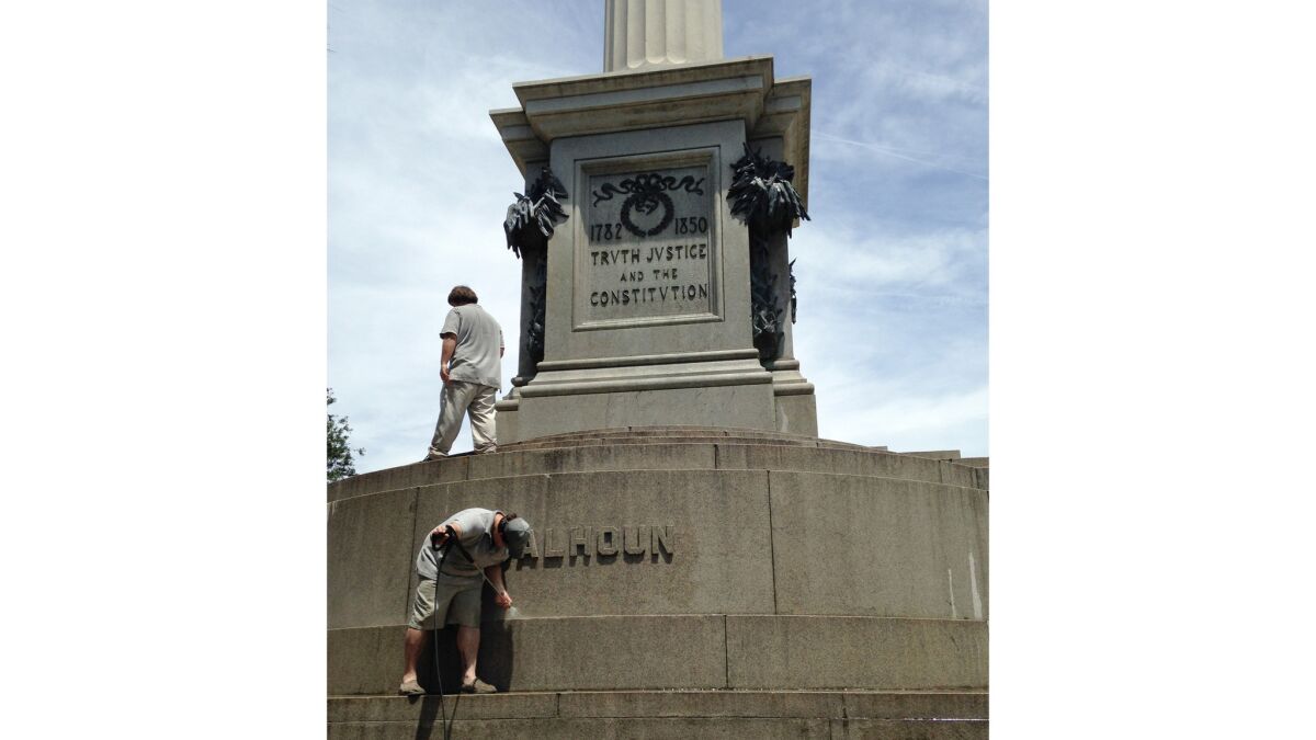 A June 23, 2015, file photo shows workmen removing graffiti from a statue of John C. Calhoun in Charleston, S.C. (Jonathan Drew / AP)