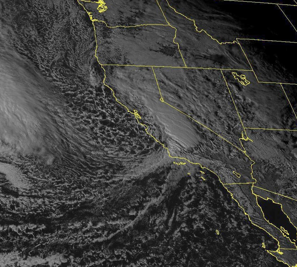 A satellite view shows clouds over the West Coast.