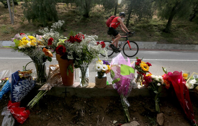 Flowers mark the location where a bicyclist was killed after being struck by a vehicle during a charity riding event