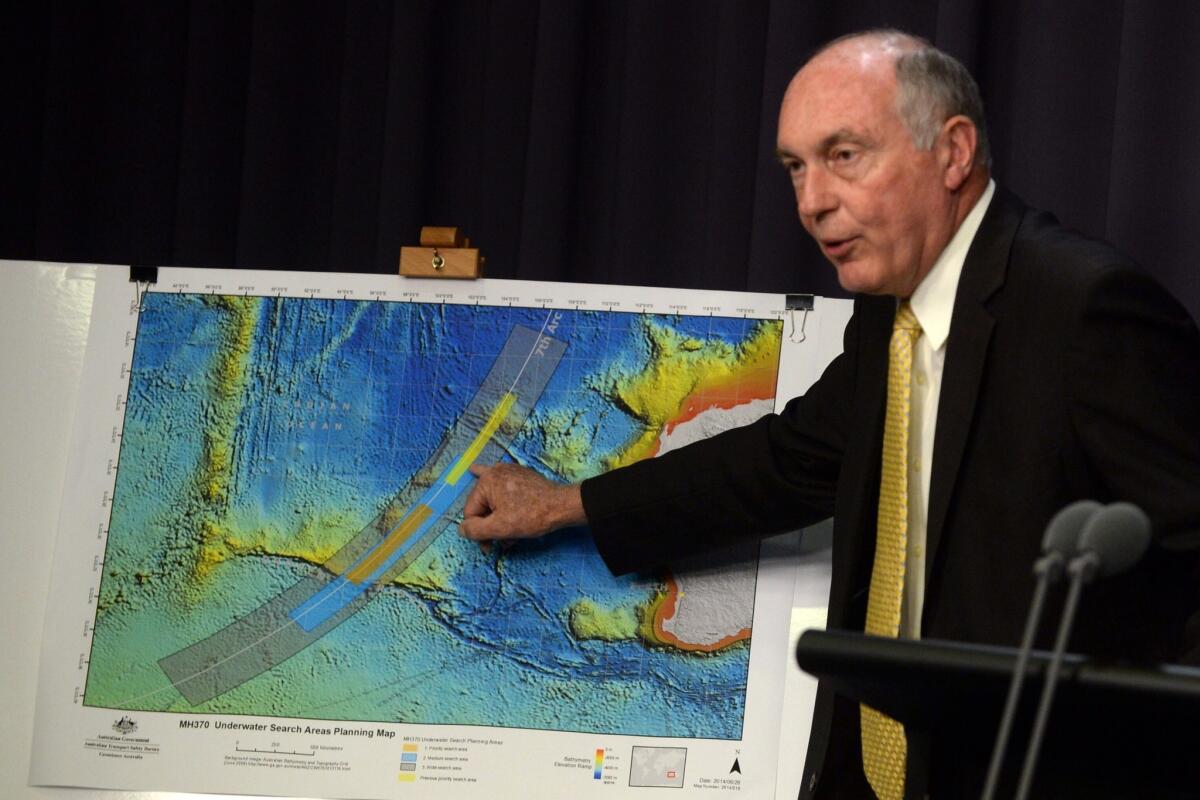 Australian Deputy Prime Minister Warren Truss shows the new search area in the Indian Ocean for the missing Malaysia Airlines jet. Truss spoke at the Parliament House in Canberra.