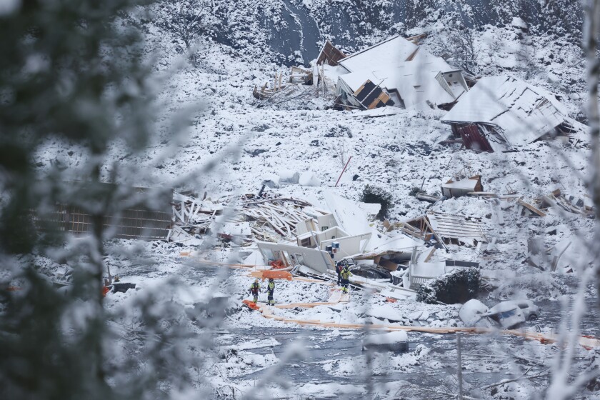 Rescue crews work in the area at Ask in Gjerdrum, Saturday Jan. 2, 2021, after a massive landslide smashed into a residential area near the Norwegian capital on Wednesday. The landslide cut across a road through Ask, leaving a deep ravine that cars could not pass. (Tor Erik Schroeder/NTB via AP)