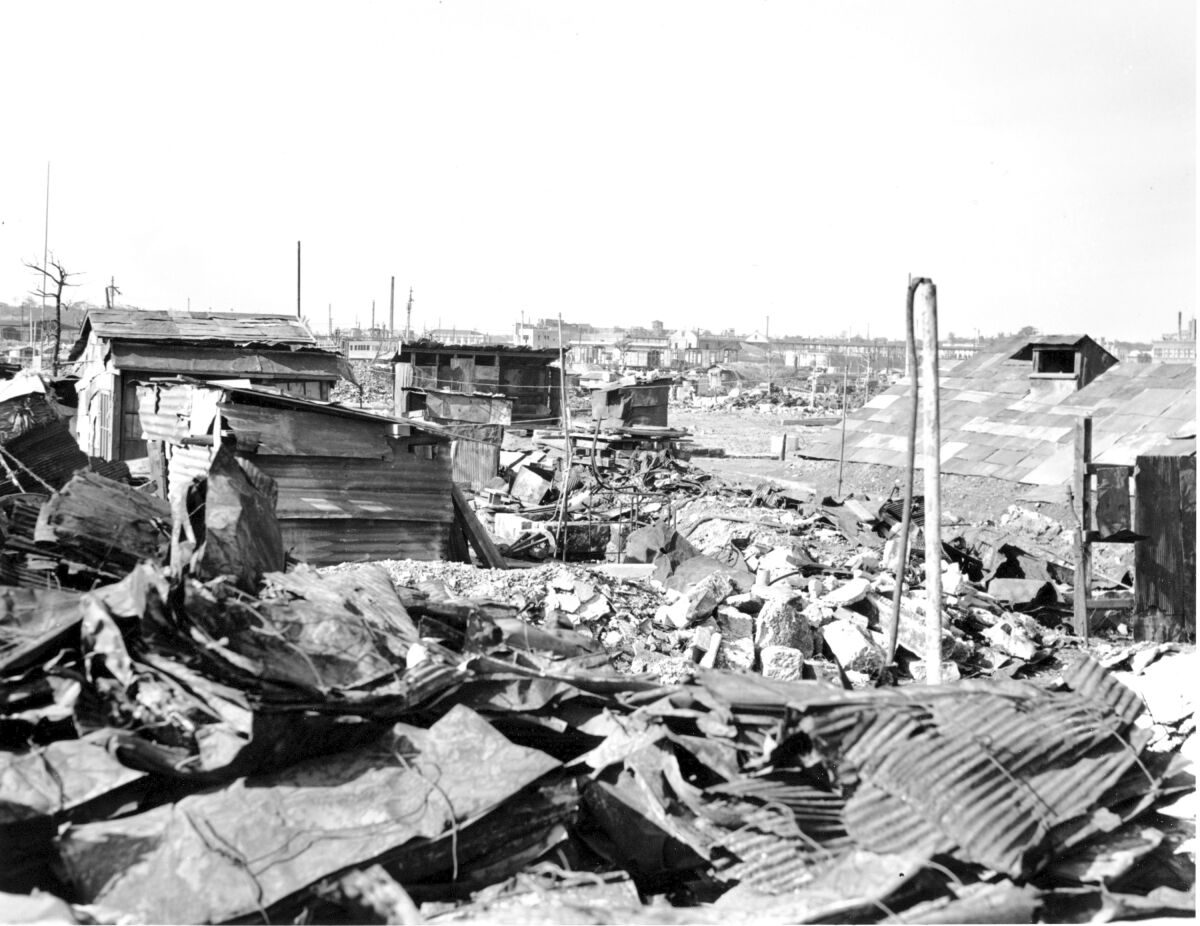 FILE - In this Sept. 7, 1945, file photo, makeshift housing built from galvanized iron roofing of burned buildings stand amid destruction and rubble in Tokyo. U.S. bombings of more than 60 Japanese cities from January 1944 to August 1945 killed an estimated 333,000 people, including the victims of the Hiroshima and Nagasaki atomic bombings. Katsumoto Saotome, a Japanese writer who gathered the accounts of survivors of the U.S. firebombing of Tokyo in World War II to raise awareness of the massive civilian deaths and the importance of peace, has died. He was 90. (AP Photo/Frank Filan, File)