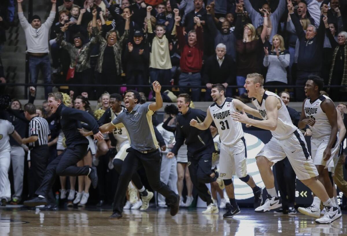 Members of the Purdue Boilermakers celebrate after beating Michigan State, 82-81, in overtime at Mackey Arena.