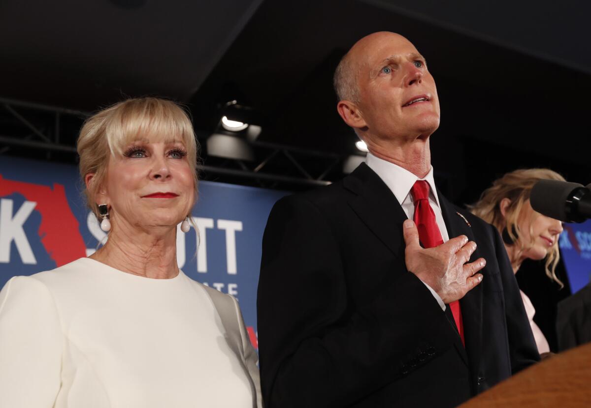 Republican Senate candidate Rick Scott speaks with his wife, Ann, by his side at an election watch party in Naples, Fla., on Nov. 7.