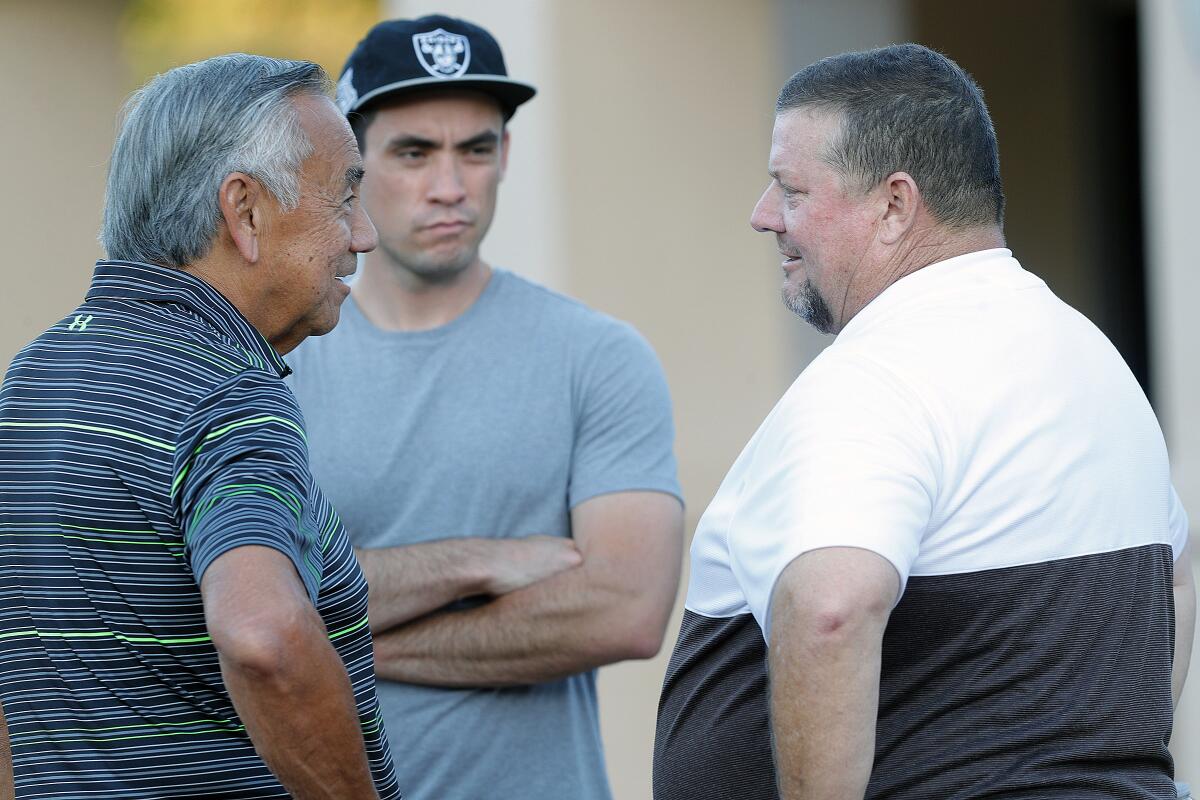  St. Francis' head coach Jim Bonds talks with Norm Chow.