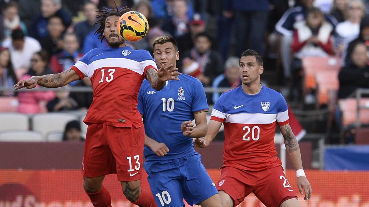 U.S. teammates Jermaine Jones, left, and Geoff Cameron, right, keep the ball away from Azerbaijan forward Rufat Dadashov during an international friendly match in San Francisco on Tuesday. Jones and Cameron's exact World Cup roles for the team remain undecided.