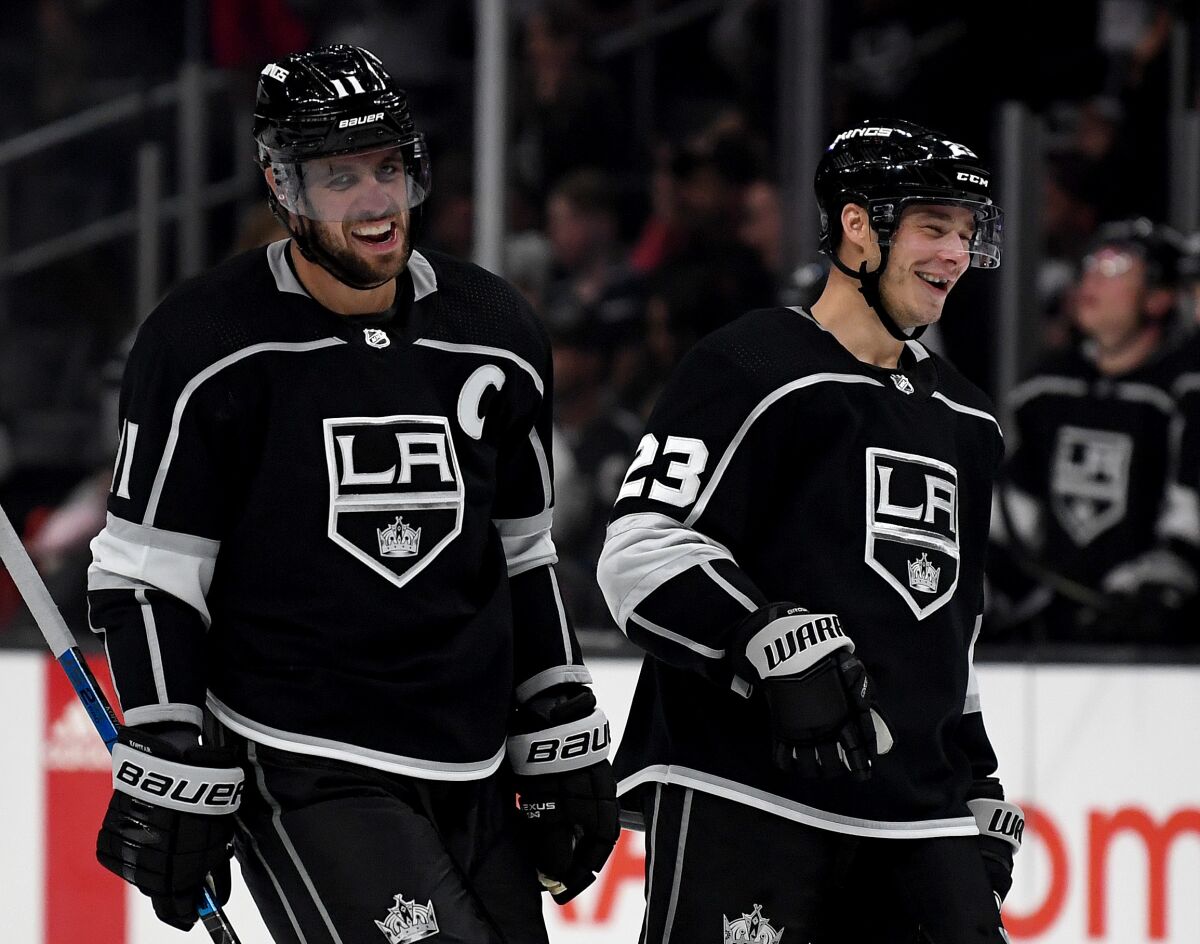 Kings forward Anze Kopitar celebrates his empty net goal with teammate Dustin Brown during a preseason win over the Ducks on Sept. 23.