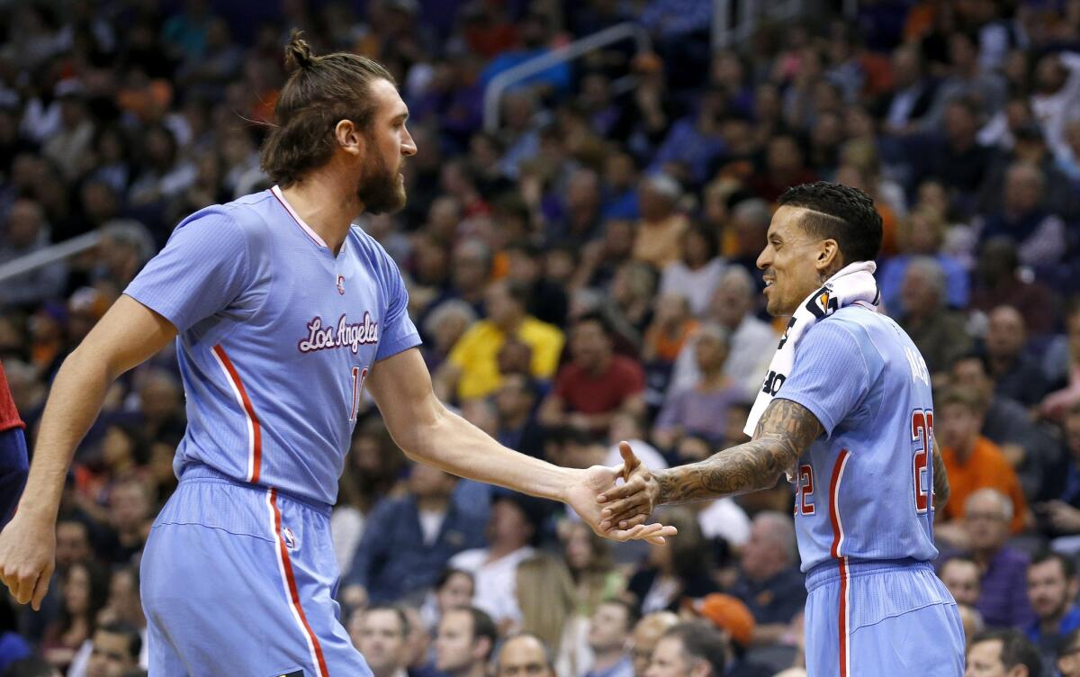 Clippers forwards Spencer Hawes, left, and Matt Barnes share a smile and slap hands during the second half of Sunday's win at Phoenix.