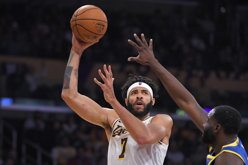 Los Angeles Lakers center JaVale McGee, left, shoots as Golden State Warriors forward Draymond Green defends during the first half of a preseason NBA basketball game Wednesday, Oct. 16, 2019, in Los Angeles. (AP Photo/Mark J. Terrill)