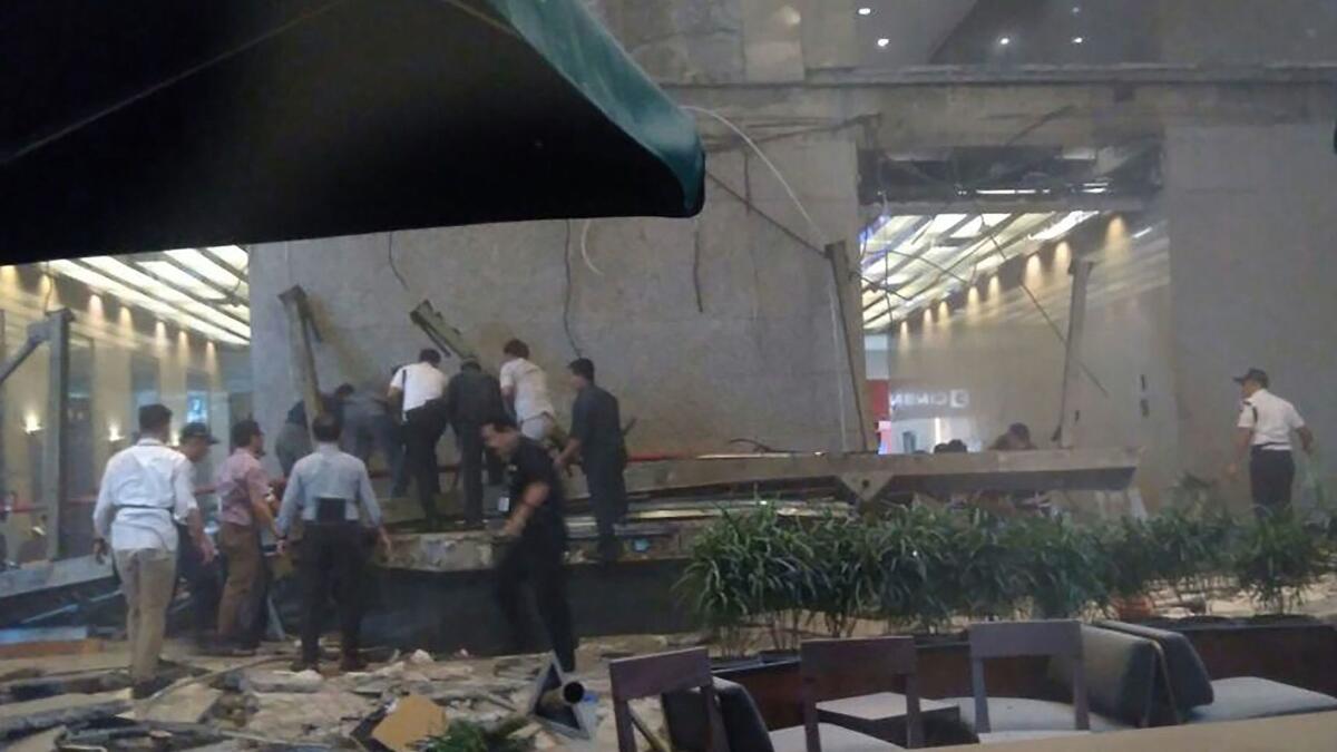 People look for victims after an internal balcony collapsed at Indonesia's stock exchange on Monday.