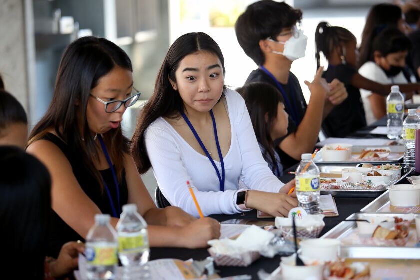 LOS ANGELES, CA - JULY 29: Sebastine (cq) Chun (cq), 16, left, an incoming junior at Chatsworth Charter High, and Katherine Shin, 17, an incoming senior at North Hollywood High, write down their results while they sample and taste new breakfast and lunch menu items at Ramon C. Cortines School of Visual and Performing Arts on Friday, July 29, 2022 in Los Angeles, CA. Los Angeles Unified Superintendent Alberto M. Carvalho host 30 students from across the District at the Ramon C. Cortines School of Visual and Performing Arts to sample and taste new breakfast and lunch menu items available to students during the 2022-23 school year. (Gary Coronado / Los Angeles Times)