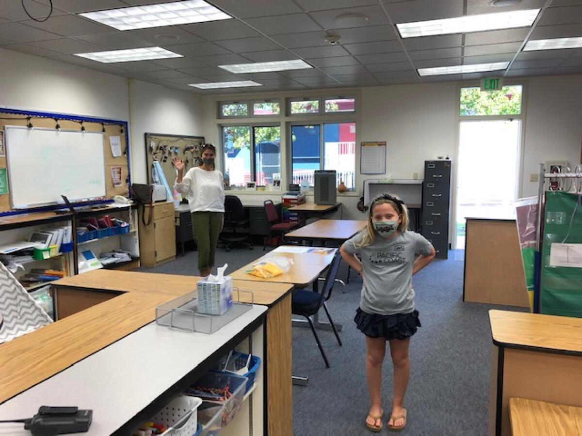 Torrey Pines Elementary student Olivia Wood and paraeducator RoseMarie Lynn in October during limited in-person learning.