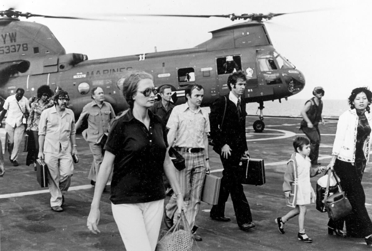 In this April 29, 1975, file photo, American citizens arrive on the USS Blue Ridge after being evacuated out of Saigon.