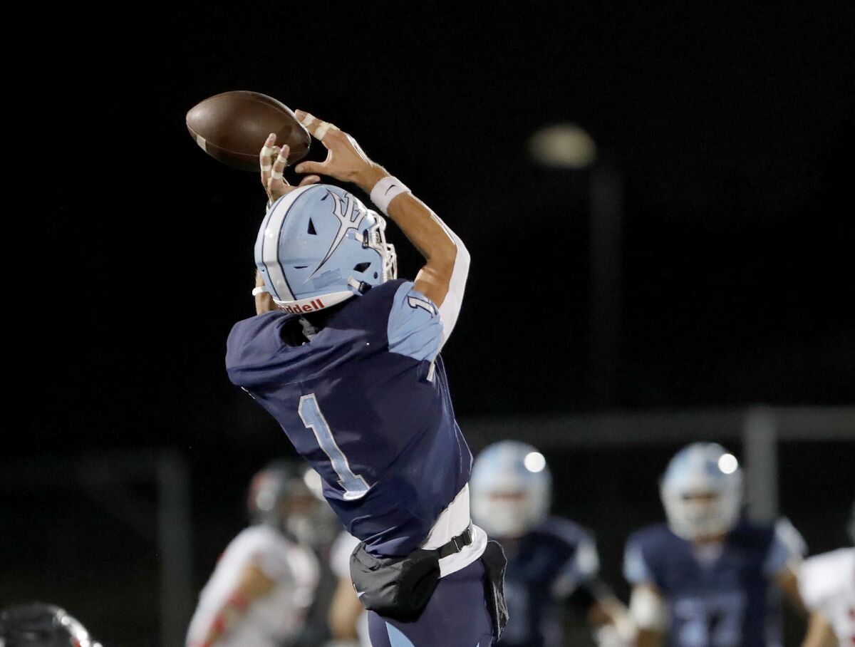 Corona Del Mar receiver Cooper Hoch makes a fingertip catch for a first down during Friday's game against San Clemente.