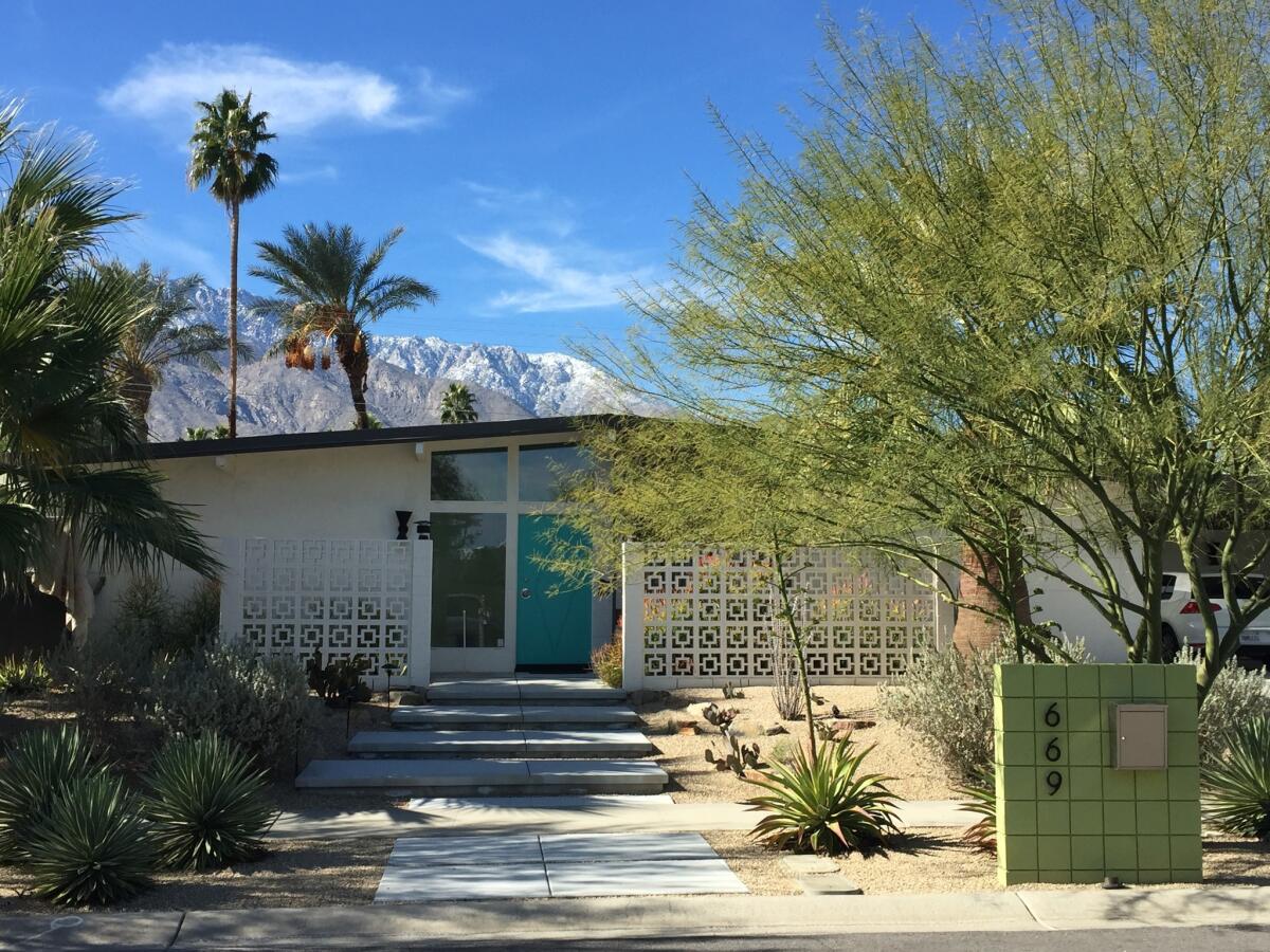 To make the front of the house more welcoming, the couple added concrete pavers, a decorative wood screen and drought-tolerant plants.