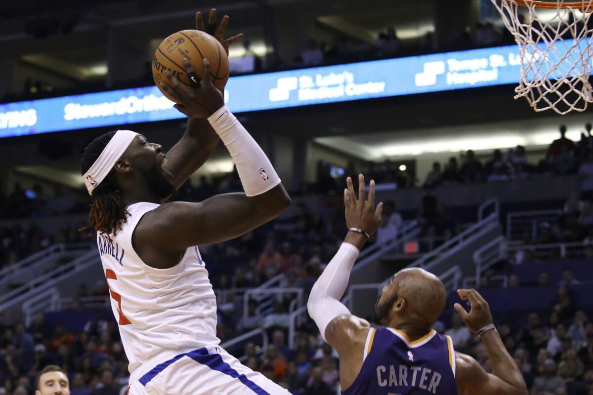 The Clippers' Montrezl Harrell, who scored a team-best 28 points, shoots over the Suns' Jevon Carter on Saturday night.