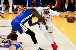 The Lakers' Anthony Davis drives on the Golden State Warriors' JaMychal Green during Game 3 on May 6, 2023, in Los Angeles.