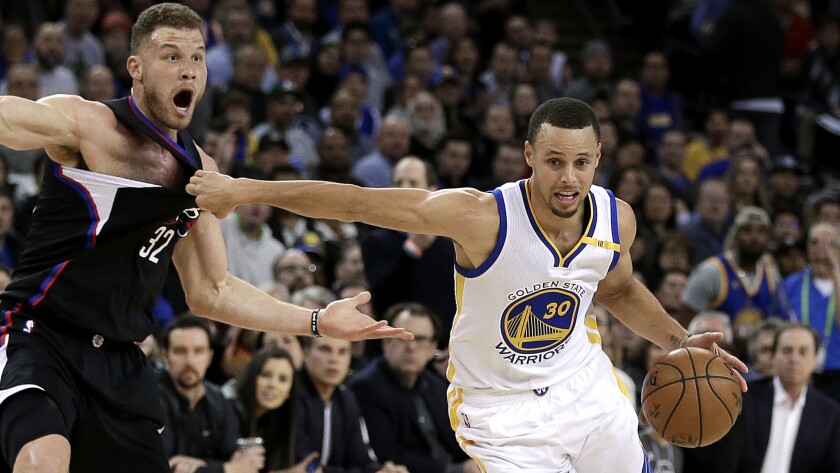 Warriors point guard Stephen Curry drives past Clippers forward Blake Griffin during the second half Thursday night.