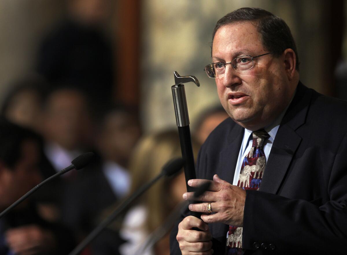 Los Angeles City Councilman Paul Koretz, holding a bullhook in 2013, as he argued for a ban on such implements to train or control elephants.