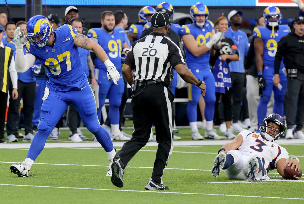 Rams defensive tackle Micheal Hoecht celebrates after sacking Broncos quarterback Russell Wilson in the third quarter.