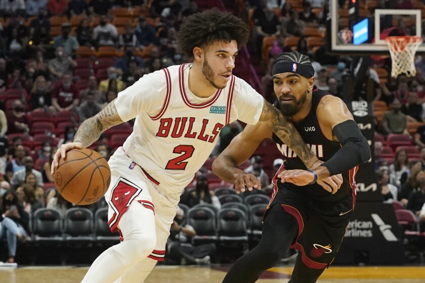 Chicago Bulls guard Lonzo Ball, left, drives to the basket as Miami Heat guard Gabe Vincent, right, defends during the first half of an NBA basketball game, Saturday, Dec. 11, 2021, in Miami. (AP Photo/Marta Lavandier)