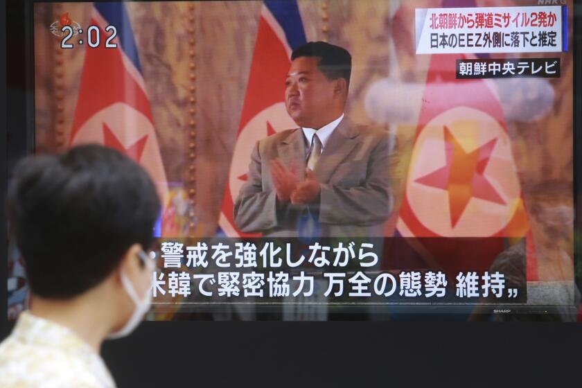 A man walks past a TV screen showing North Korean leader Kim Jong Un, in Tokyo, Wednesday, Sept. 15, 2021. North Korea fired two ballistic missiles into waters off its eastern coast Wednesday afternoon, two days after claiming to have tested a newly developed missile in a resumption of its weapons displays after a six-month lull. (AP Photo/Koji Sasahara)