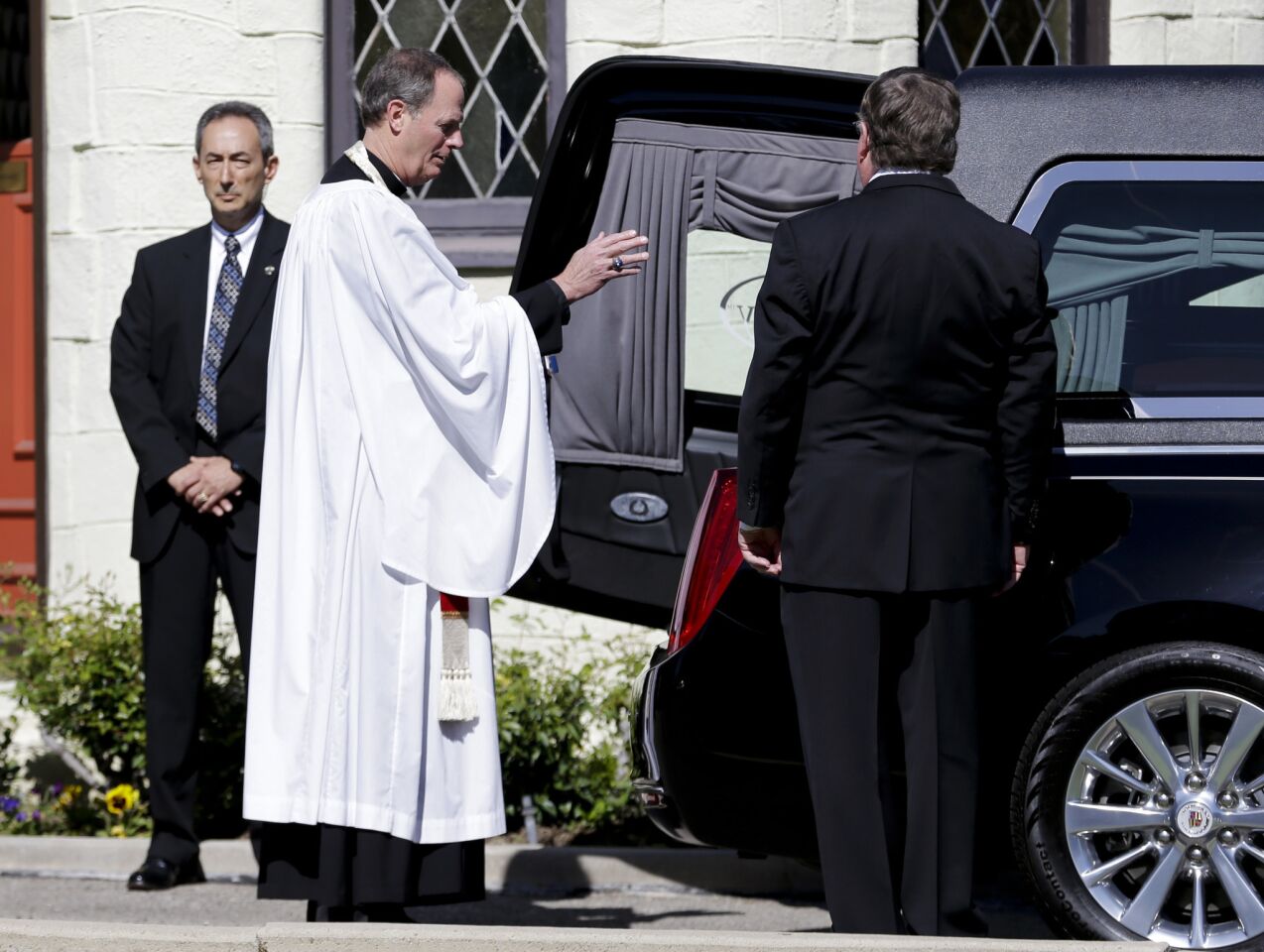 The Rev. Ken Worthy Stuart, Vicar of the Washington National Cathedral, gives the final blessing after the casket carrying the former first lady Nancy Reagan was loaded into a hearse at a mortuary in Santa Monica, Calif.