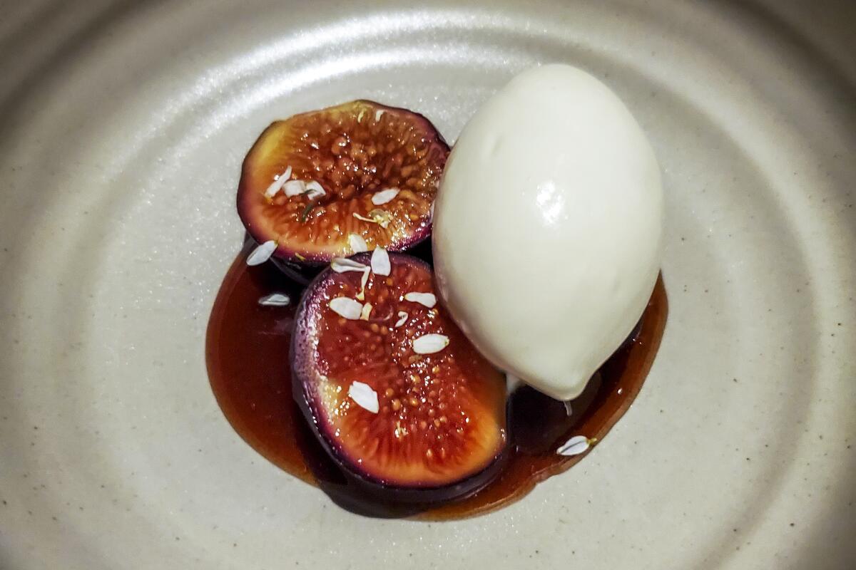A dish featuring fig and a dark sauce served on a plate.