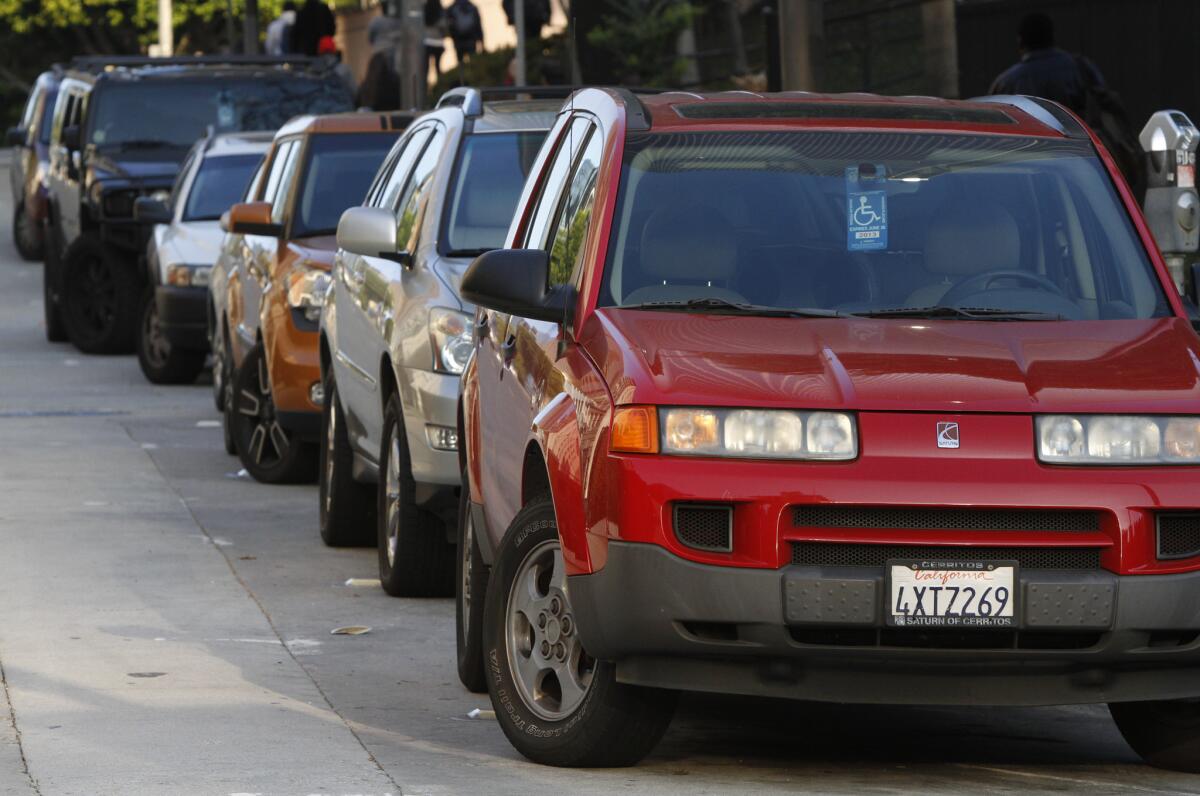 A line of cars displaying disabled placards are parked near 4th and Hill in downtown Los Angeles on Feb. 10, 2012.
