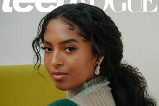 A woman with long, black hair posing on a Teen Vogue magazine cover