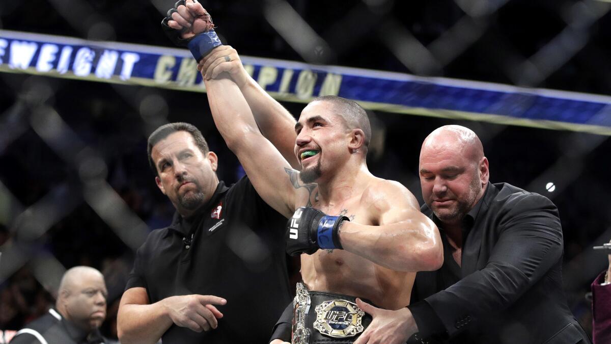 Robert Whittaker celebrates after defeating Yoel Romero for the interim middleweight championship at UFC 213.