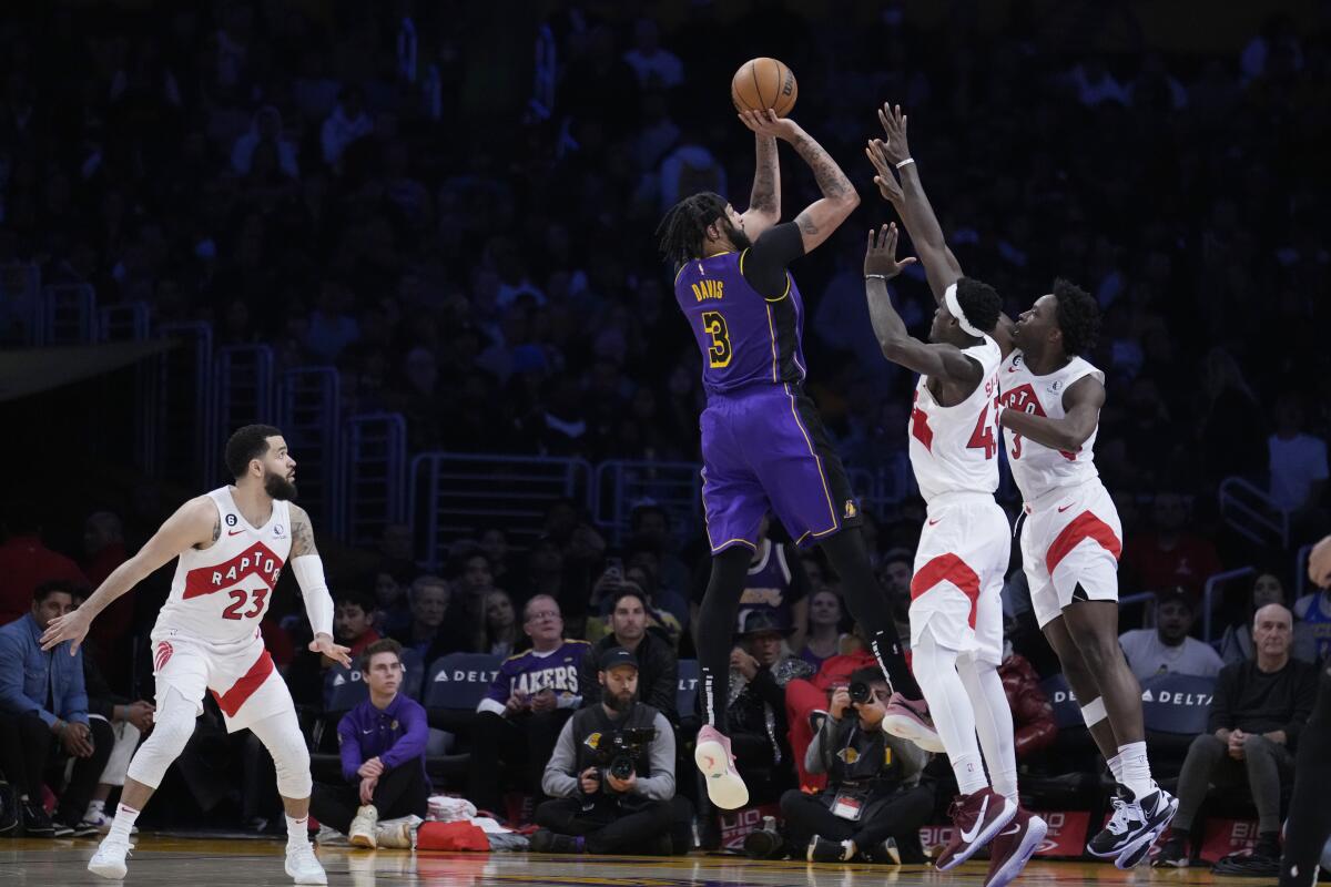 Anthony Davis shoots over Toronto Raptors forward Pascal Siakam and forward O.G. Anunoby.