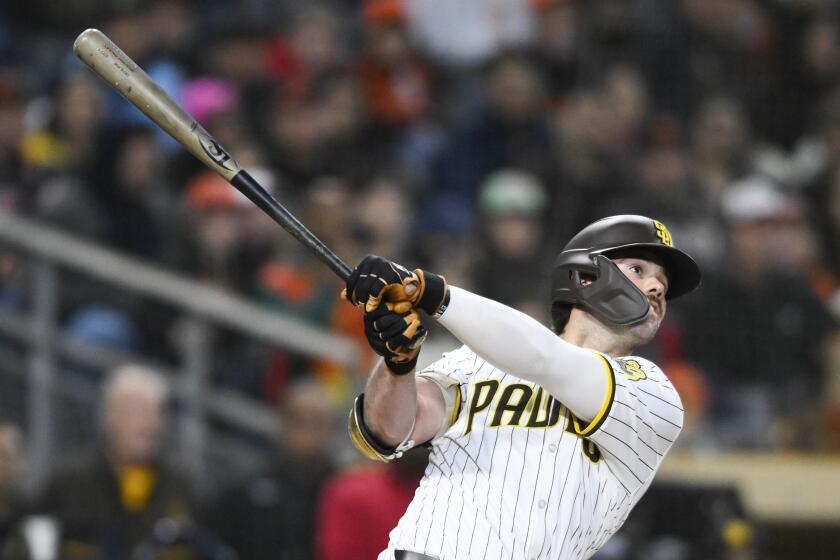 San Diego Padres' Graham Pauley hits a three-run home run during the ninth inning of a baseball game against the San Francisco Giants, Saturday, March 30, 2024, in San Diego. (AP Photo/Denis Poroy)