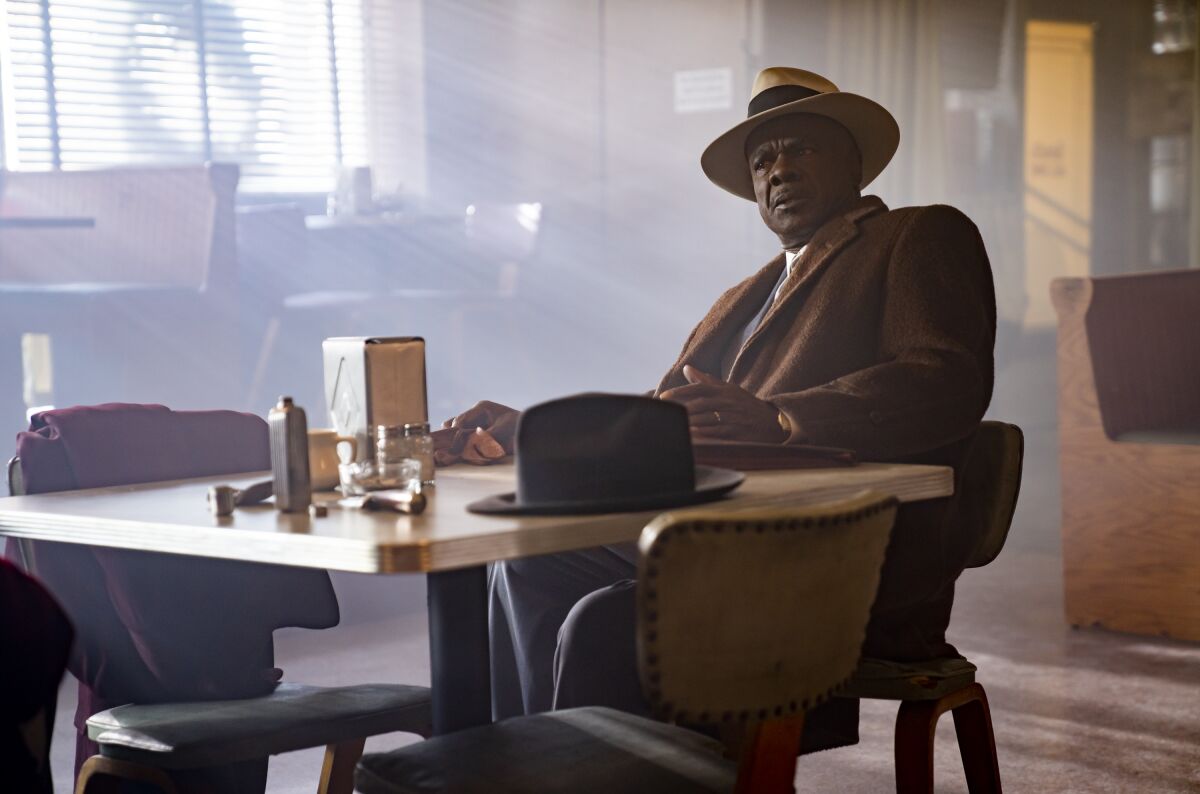 Glynn Turman in character in "Fargo" sits at a restaurant table with light streaming in the window behind him.