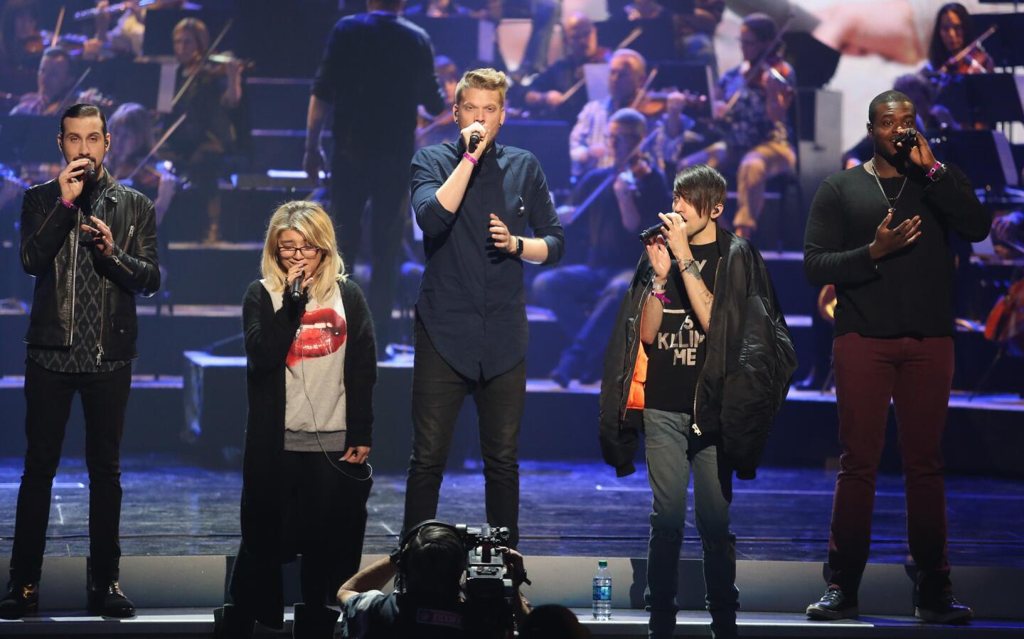 Singers Avi Kaplan, from left, Kirstin Maldonado, Scott Hoying, Mitch Grassi and Kevin Olusola of Pentatonix rehearse for the American Music Awards.