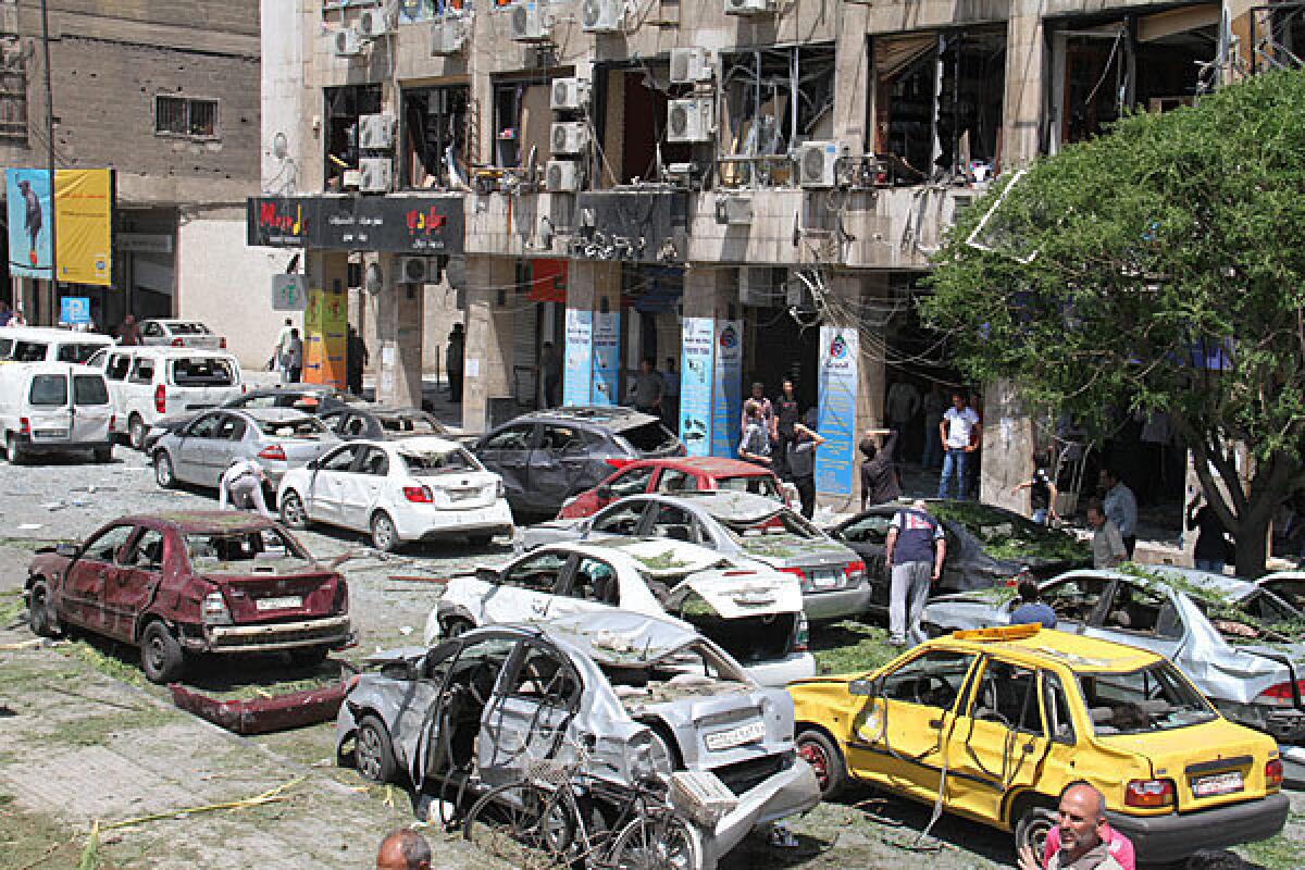 Damaged cars are seen at the scene of an explosion in the heart of Damascus.