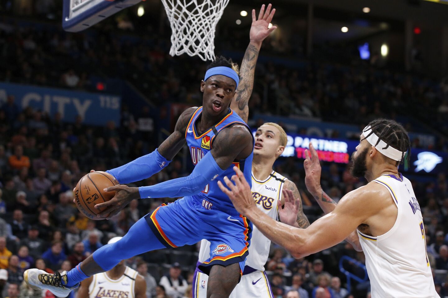 Thunder guard Dennis Schroder passes from under the basket during a game against the Lakers on Jan. 11 at Chesapeake Energy Arena.