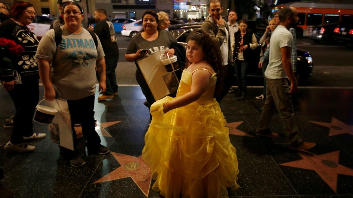Dressed in yellow as Belle, Samantha Ruiz, 7, of Monterey Park leaves Hollywood's El Capitan Theatre after the first L.A. public screening of "Beauty and the Beast" on Thursday.