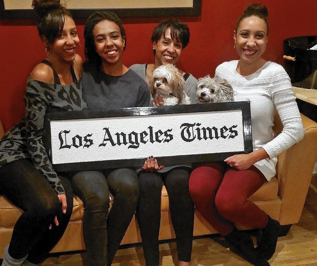 Sandy Banks, second from right, with daughters Danielle, Brittany and Alyssa Robinson and dogs Lola and Rio.