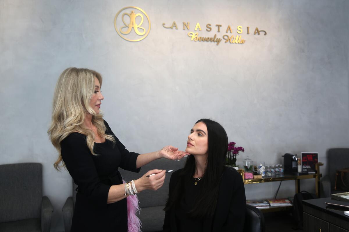 Anastasia Soare, left, works on Gray Tracy's eyebrows to demonstrate how she shapes her clients' brows. Soare's business, Anastasia Beverly Hills, focuses on the golden ratio method to achieve spot-on brows.