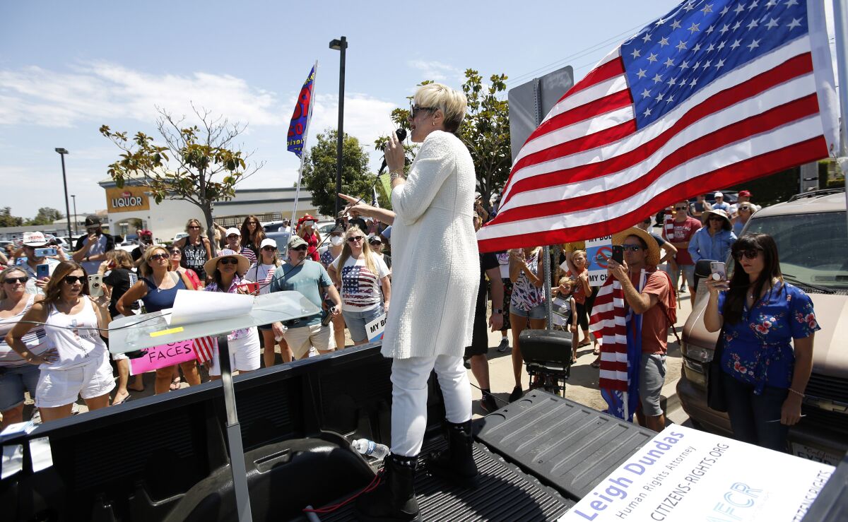 Human rights attorney Leigh Dundas spoke to attendees near Mother's Market and Kitchen during rally against mask orders.