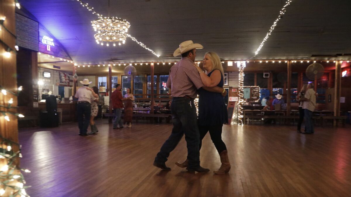 Michelle Boop, left, with husband Bill, brought her entire family, including her grandson Zane, 2, center, his mother Kayla Casey, right, and older brother, Zander, 6, for a night of dancing at Twin Sisters Dance Hall. (Katie Falkenberg / Los Angeles Times)