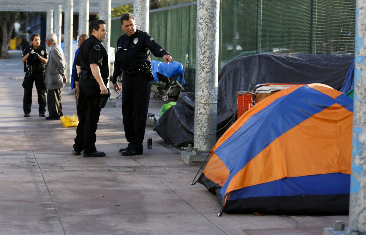 L.A. County supervisors voted Tuesday to establish a "sobering center" on skid row to serve dangerously intoxicated people, including those living on the streets. Above, a homeless encampment above the 101 Freeway last week.