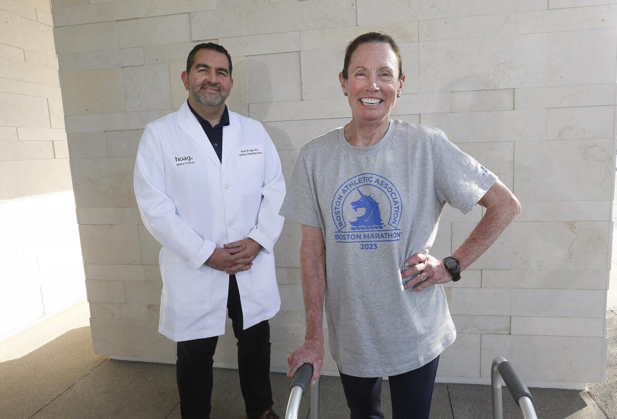 Dr. Burak Ozgur, director of the Hoag Spine Center, and marathoner Beth Sanden, at the Hoag Spine Center in Irvine.