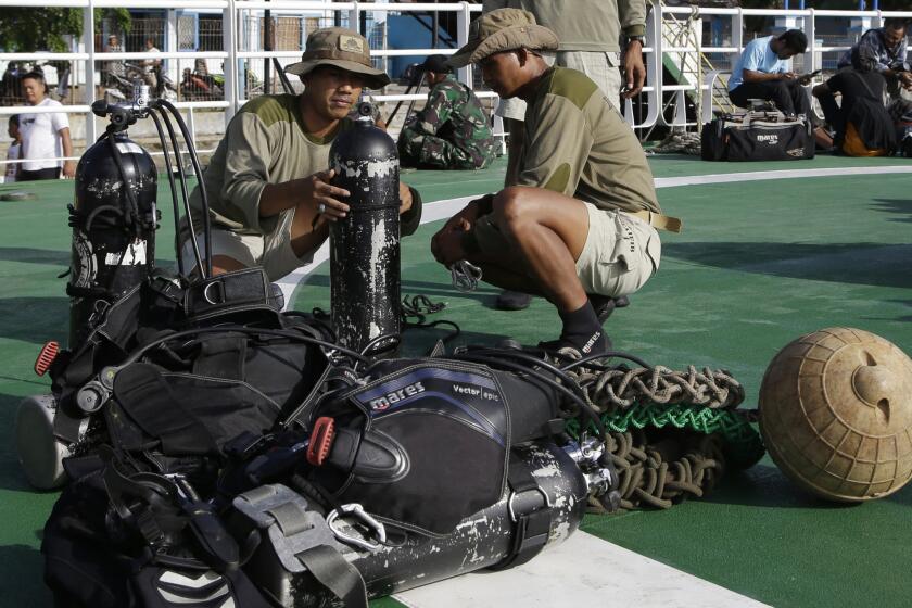 Indonesian navy divers check their gear at Kumai port in Pangkalan Bun, Indonesia, in preparation for a search operation for victims of AirAsia Flight 8501 on Jan. 1.