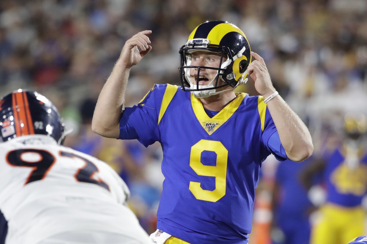 Rams quarterback John Wolford signals during a preseason game against the Denver Broncos.